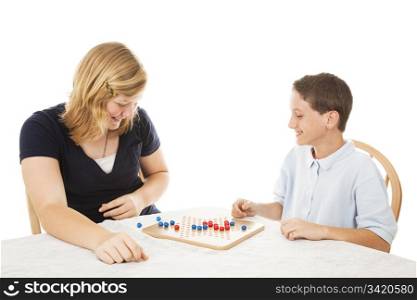 Brother and sister playing a board game together. Isolated on white.