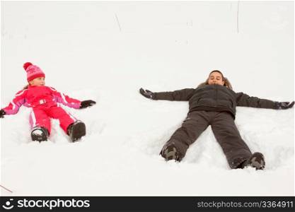 Brother and sister playing Snow Angels.