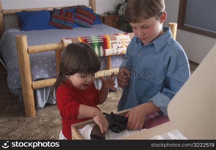 Brother and Sister Playing with a Gun