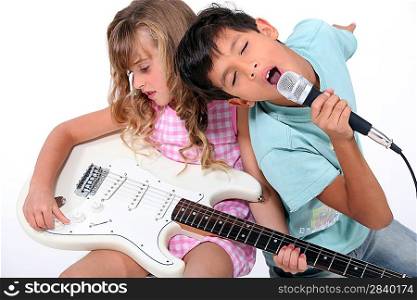 Brother and sister practicing musical instruments