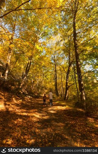 Brother and sister walking in the beautiful Fall scenery in Upstate New York.