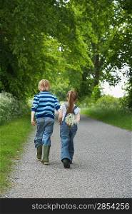 Brother and Sister Walking on Rural Road