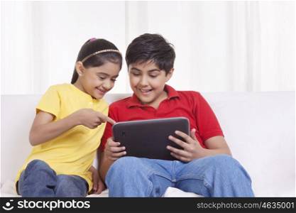 Brother and sister with digital tablet