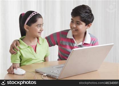 Brother and sister with laptop