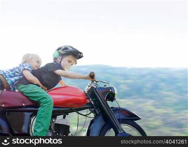 Brothers riding motorcycle