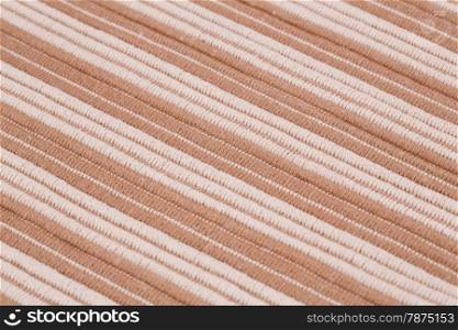 Brown and white knitted cloth as a background.