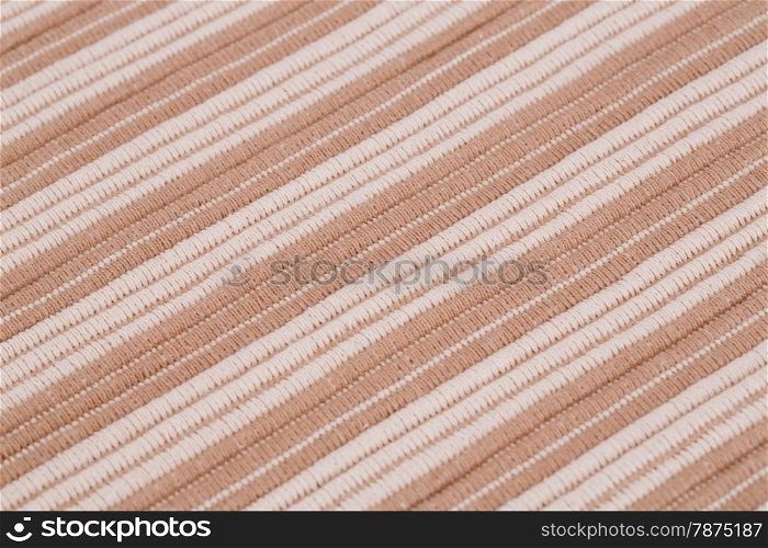 Brown and white knitted cloth as a background.