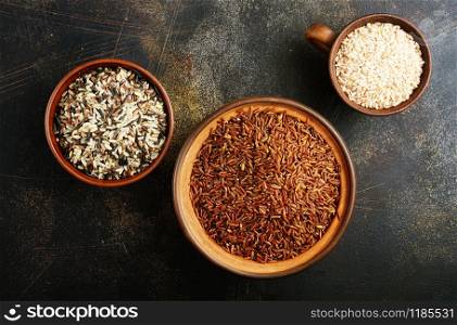 brown and white rice in bowls on a table