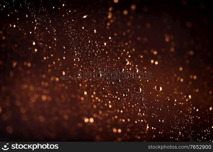 Brown background with water drops, rainy weather at night, rain drops on the window, abstract textured wallpaper, autumn season concept
