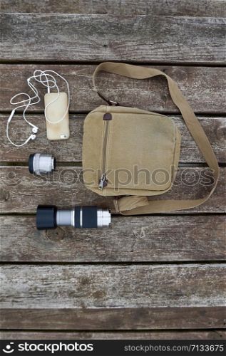 brown backpack and accesories on the ground