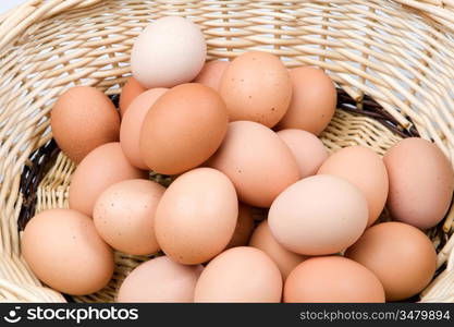 Brown basket with a lot of hen eggs