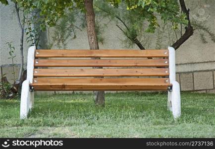 Brown bench on green meadow