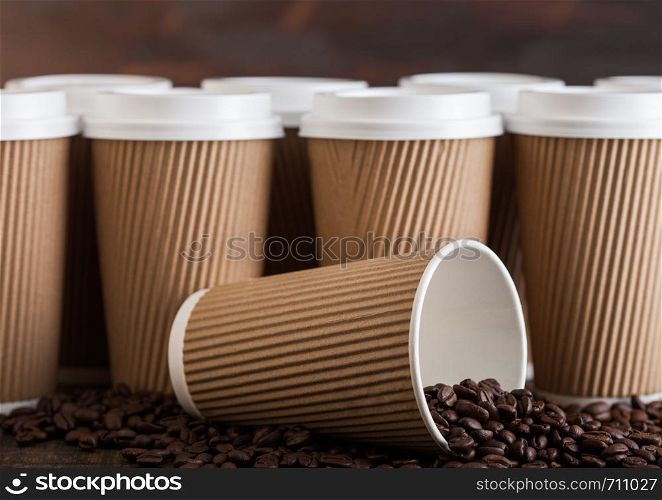 Brown Blank Coffee Paper Cup for take away with coffee beans on wood.