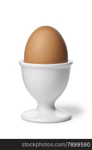 Brown boiled egg in an eggcup in an eggcup
