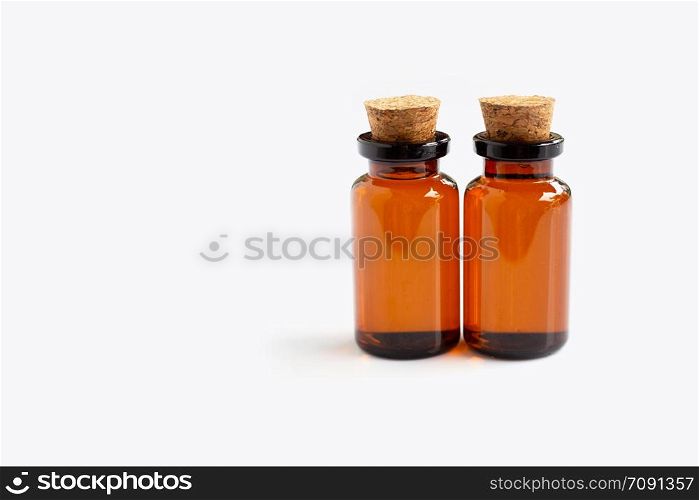 Brown bottle with essential oils on white background