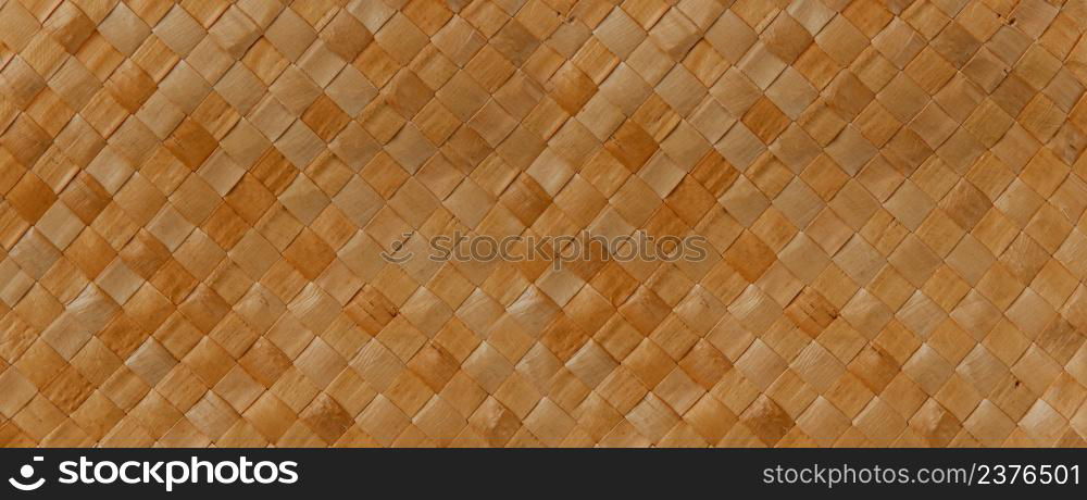 Brown braided reed texture. Closeup background. Horizontal banner. Brown braided reed texture background