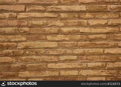 Brown brick wall in cream beige color pattern background