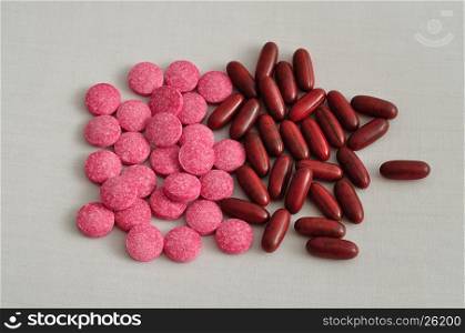 Brown capsules and pink tablets