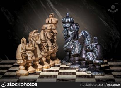 brown chess pieces facing black pieces on an abstract background