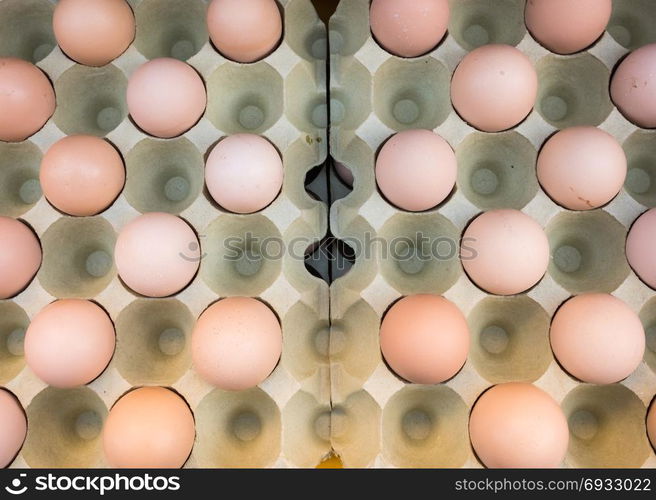 Brown chicken eggs placed in cardboard boxes at the market,view from above,outdoor.