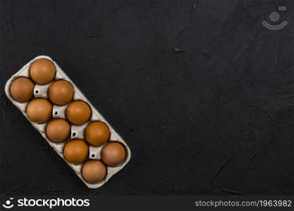 brown chicken eggs rack black table. High resolution photo. brown chicken eggs rack black table. High quality photo