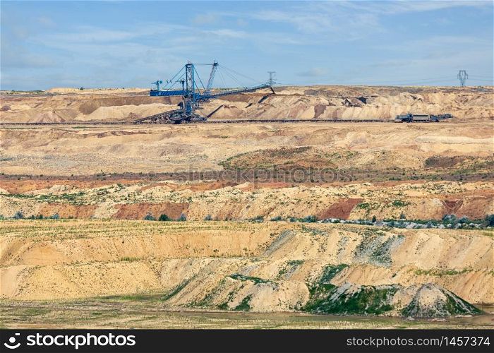 Brown coal open pit landscape with enormous digging excavator in Matra mine Hungary, east of Budapest. Brown coal open pit landscape with digging excavator in Hungary