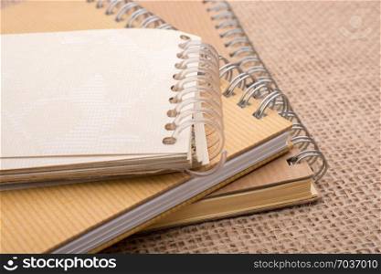 brown color spiral notebook placed on a canvas background