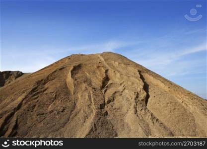 brown construction sand quarry mountain blue sky
