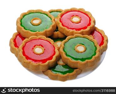 Brown Cookies with red and green jelly on a white plate, isolated