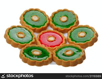 Brown Cookies with red and green jelly on a white plate, isolated