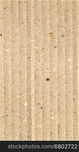 Brown corrugated cardboard background - vertical. Brown corrugated cardboard useful as a background - vertical