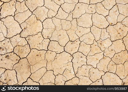 Brown dry soil or cracked ground texture background.