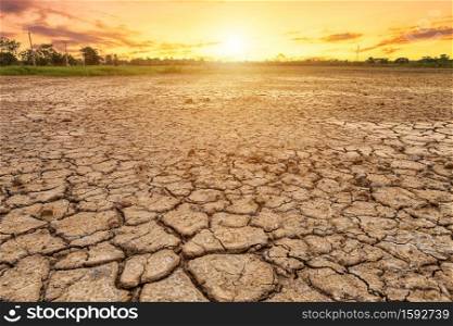 Brown dry soil or cracked ground texture on blue sky background with white clouds sunset,Global warming