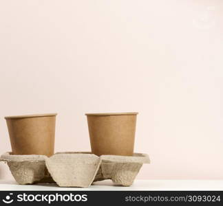 brown eco friendly disposable paper cups on a white table