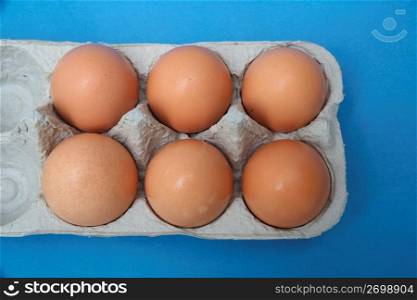 Brown eggs in carton, overhead view