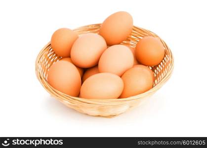 Brown eggs in the basket on white