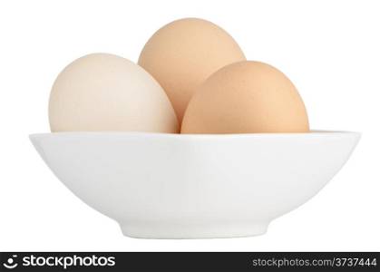 Brown eggs in white ceramic bowl isolated on white background.