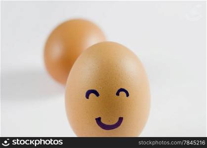 brown eggs with happy face on white background