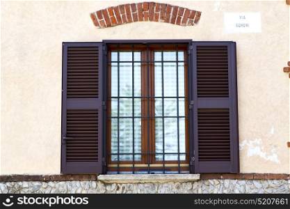 brown europe italy lombardy in the milano old window closed brick abstract grate