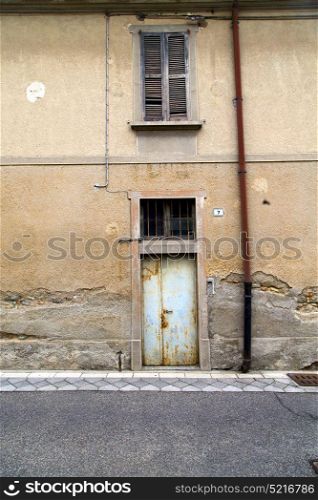 brown europe italy lombardy in the milano old window closed brick abstract grate door terrace