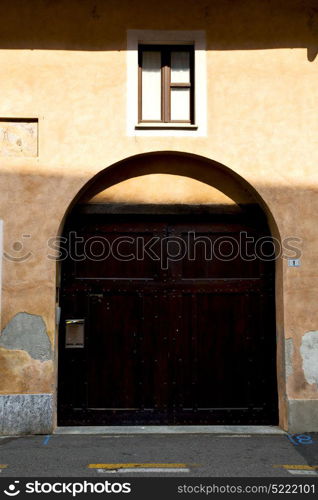 brown europe italy lombardy in the milano old window closed brick abstract grate door terrace