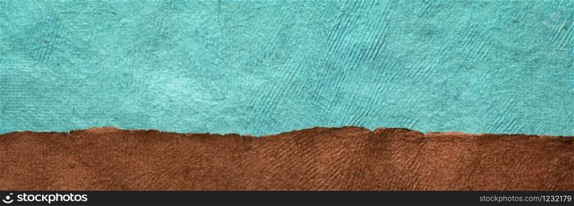 brown field and turquoise blue sky - abstract landscape created with colorful sheets of handmade textured paper
