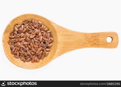 brown flax seeds on a small wooden spoon isolated on white with a clipping path