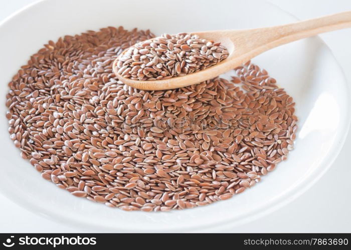 Brown flax seeds on a wooden spoon, stock photo