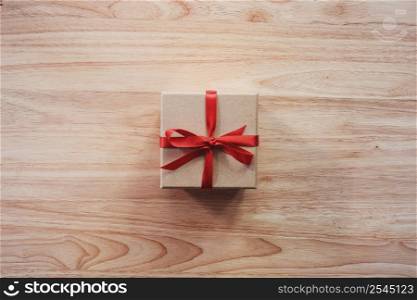 Brown gift box on wooden table background with copy space