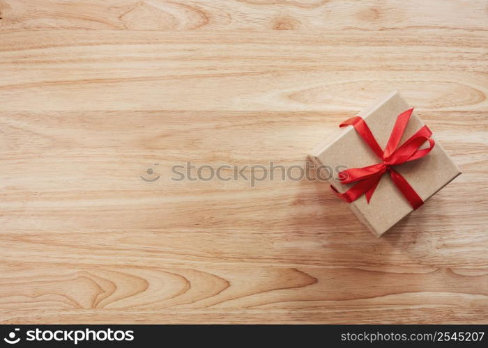 Brown gift box on wooden table background with copy space