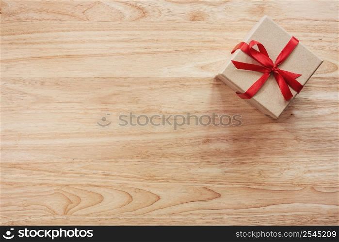 Brown gift box on wooden table background with copy space