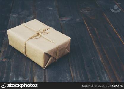 brown gift box on wooden table background with copy space.