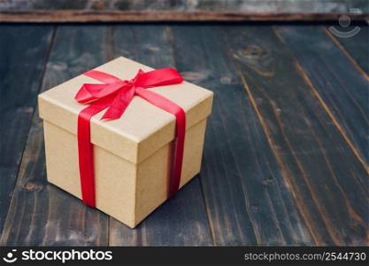 Brown gift box on wooden table with copy space.