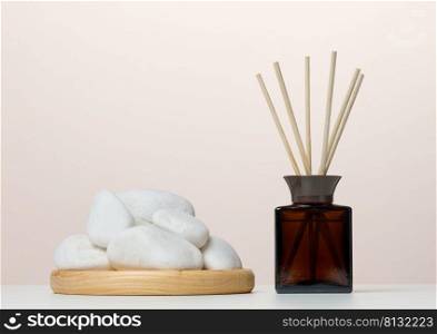 Brown glass bottle and wooden sticks, home fragrance